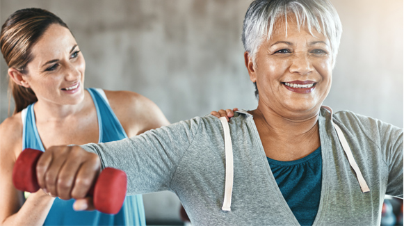 Male riding bike while female runner follows